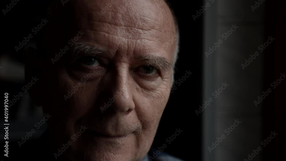 Portrait close - up of a sad elderly bald man looking into the camera. Located in the room. Portrait close - up of a sad elderly bald man looking into the camera. Located in the room.