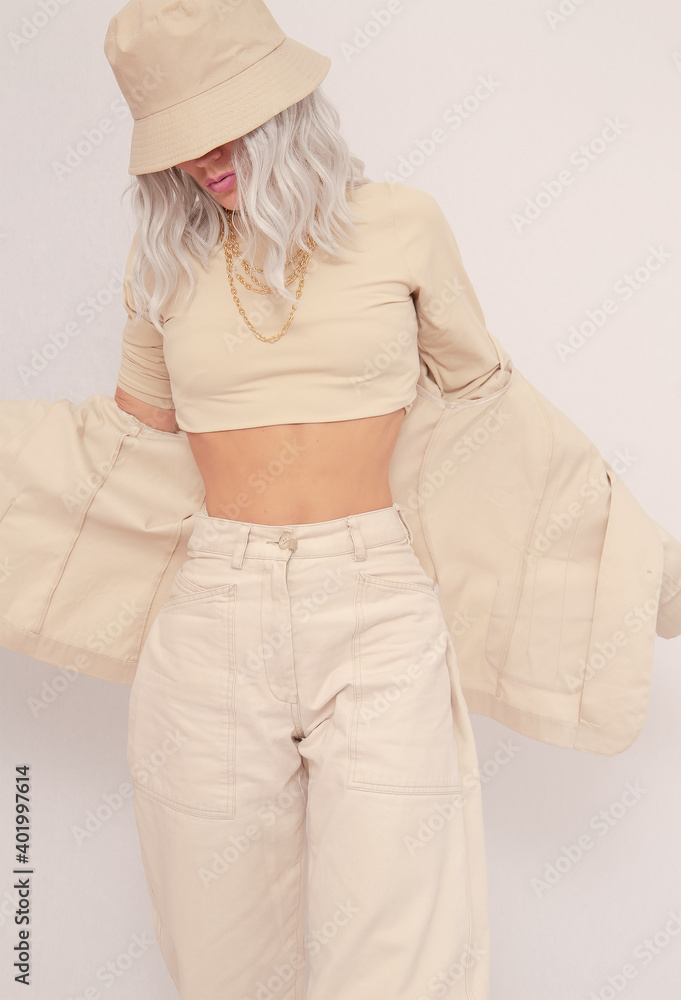 Urban street style Girl. Details of everyday look. Casual beige outfit and accessories. Bucket hat. Trendy Minimalist fashion Urban street style Girl. Details of everyday look. Casual beige outfit and accessories. Bucket hat. Trendy Minimalist fashion