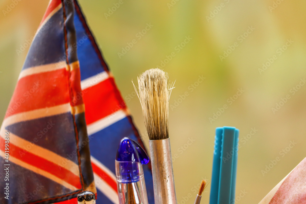 Fototapeta premium paint brushes and flags sitting in a kitchen pot
