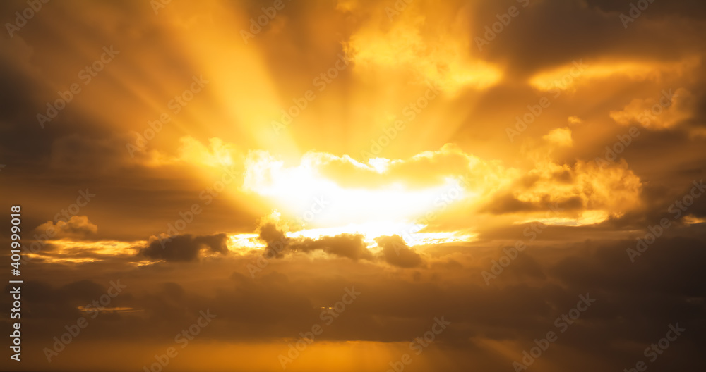 Orange clouds crossed by bright sunlight Orange clouds crossed by bright sunlight