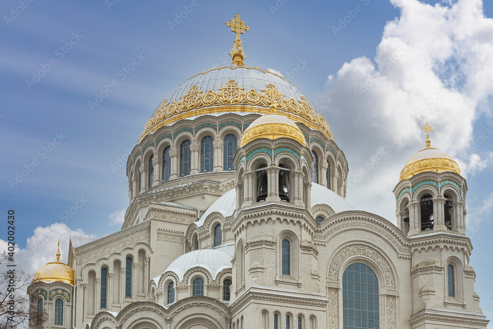 Front view of the facade of the Naval Cathedral in Kronstadt, Russia against a blue autumn sky