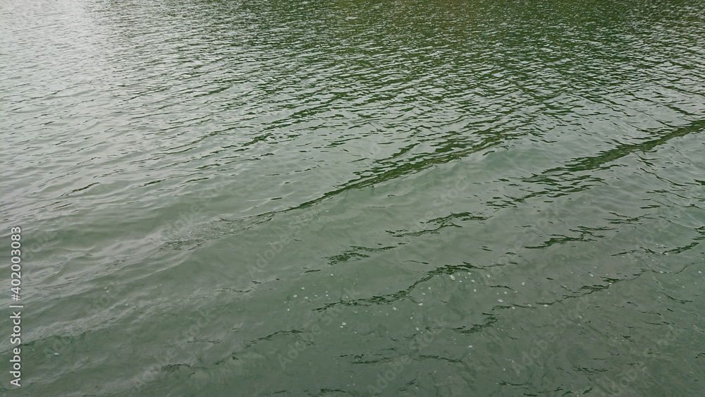 Looking at the surface of a large and beautiful mountain lake Looking at the surface of a large and beautiful mountain lake