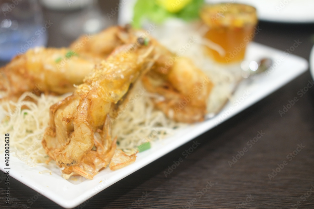 Crispy fried prawn with garlic and pepper in white plate Crispy fried prawn with garlic and pepper in white plate