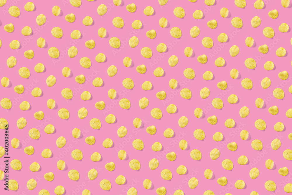 background made from Potato chips on pink background flat lay. potato snack chips isolated Fast food banner.