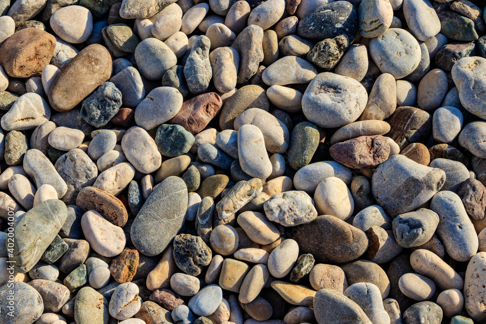 Smooth round pebbles texture background. Pebble sea beach close-up Smooth round pebbles texture background. Pebble sea beach close-up