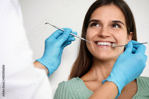 Dentist examining patient s teeth in modern clinic. Cosmetic dentistry