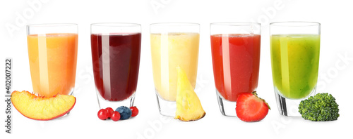 Glasses of delicious juices and fresh ingredients on white background