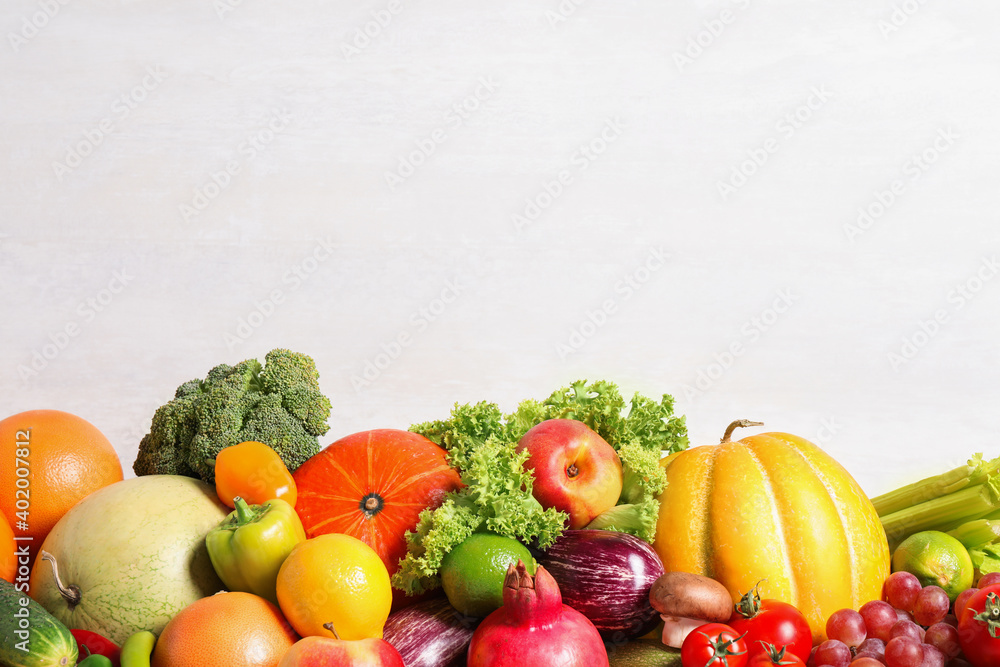 Assortment of fresh organic fruits and vegetables on light background, closeup. Space for text Assortment of fresh organic fruits and vegetables on light background, closeup. Space for text