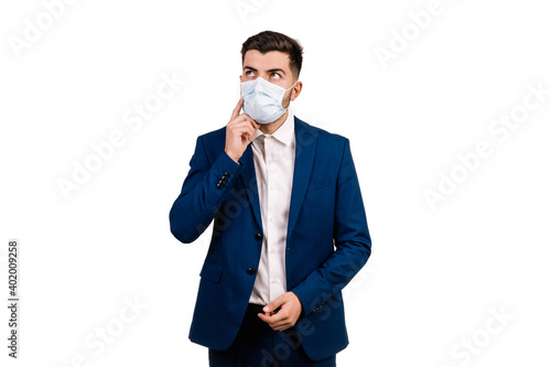 Young businessman talking about work on the mobile phone with protective mask on isolated over a white background