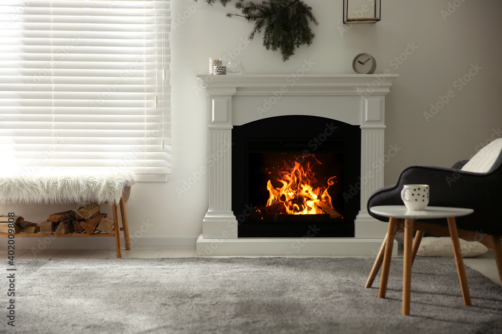 Bright living room interior with artificial fireplace and firewood - obrazy, fototapety, plakaty 