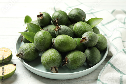 Fresh green feijoa fruits on white wooden table