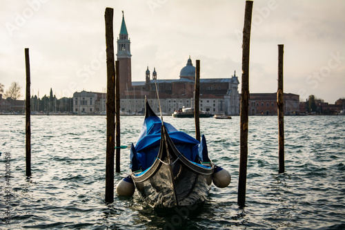 A Gondola moored in front of St Mark's Square and Island of San Giorgio Maggiore in the background in the lagoon of Venice in Veneto, Italy