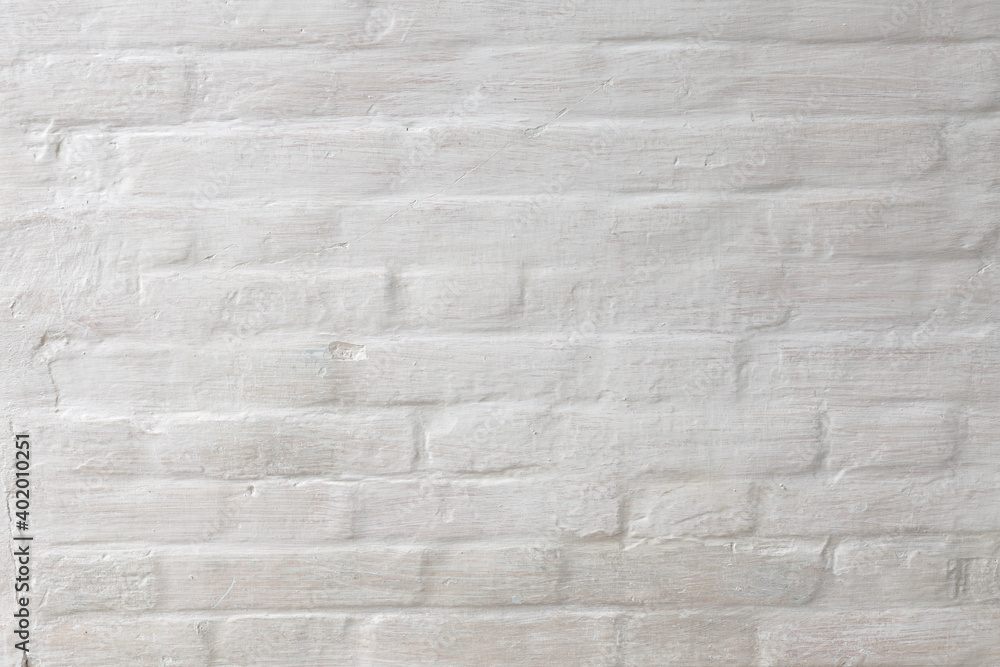 Abstract weathered texture stained old stucco light gray and aged paint white brick wall background in rural room Abstract weathered texture stained old stucco light gray and aged paint white brick wall background in rural room