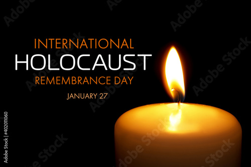 International Holocaust Remembrance Day January 27. Burning candle on black background, closeup