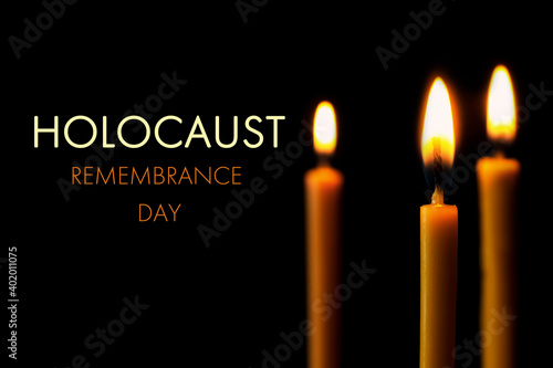 International Holocaust Remembrance Day. Burning candles on black background