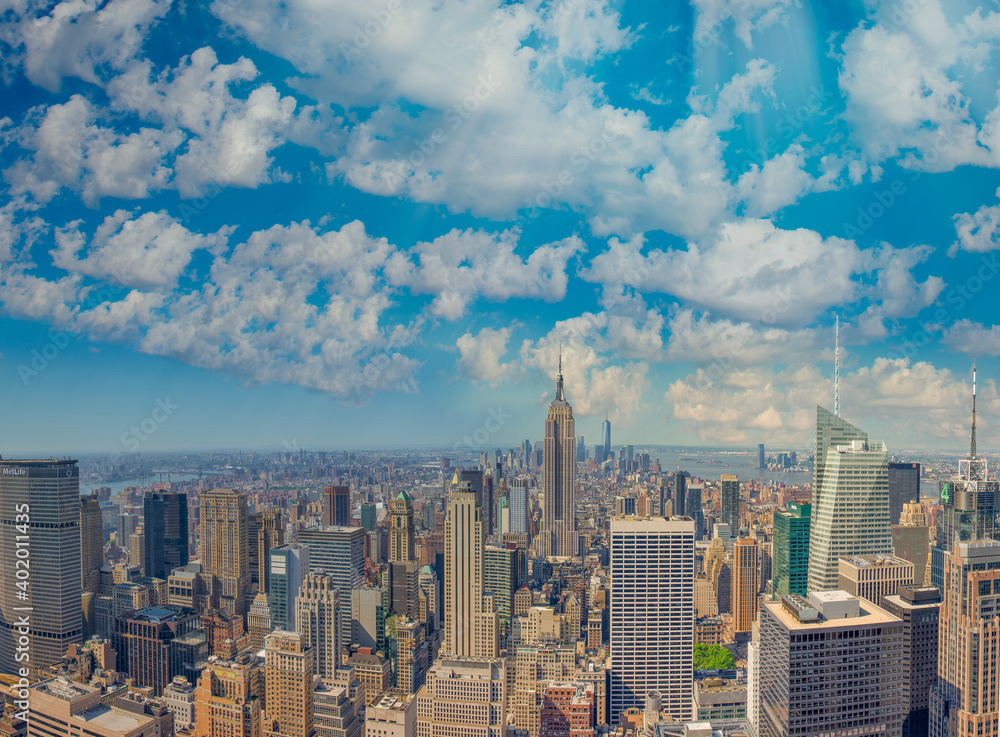 NEW YORK CITY - JUNE 10, 2013: Panoramic aerial view of Manhattan from a city rooftop at sunset