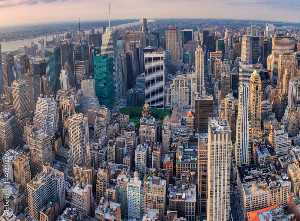 Midtown Manhattan at sunset, New York City. Panoramic aerial view of city skyscrapers at dusk