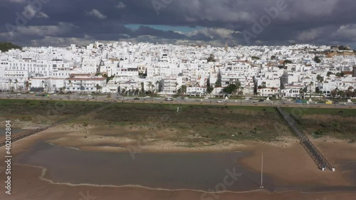 Aerial drone video of beach in Conil de la Frontera and white town of Cadiz, Andalusia