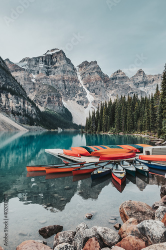 Canoes on a jetty on the turquoise waters of Moraine Lake, located in Banff National Park, Alberta, Canada, situated in the Valley of the Ten Peaks. The peaks are known as the "Twenty Dollar View".