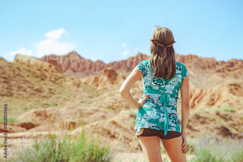 girl standing on the road with her back