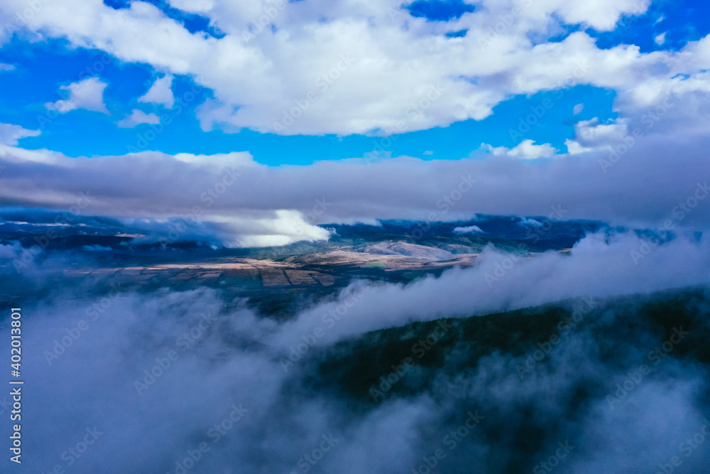 Foggy valley, fall season landscape, fields. Fall season weather, drone flight through the clouds, aerial backdrop. Foggy valley, fall season landscape, fields. Fall season weather, drone flight through the clouds, aerial backdrop.