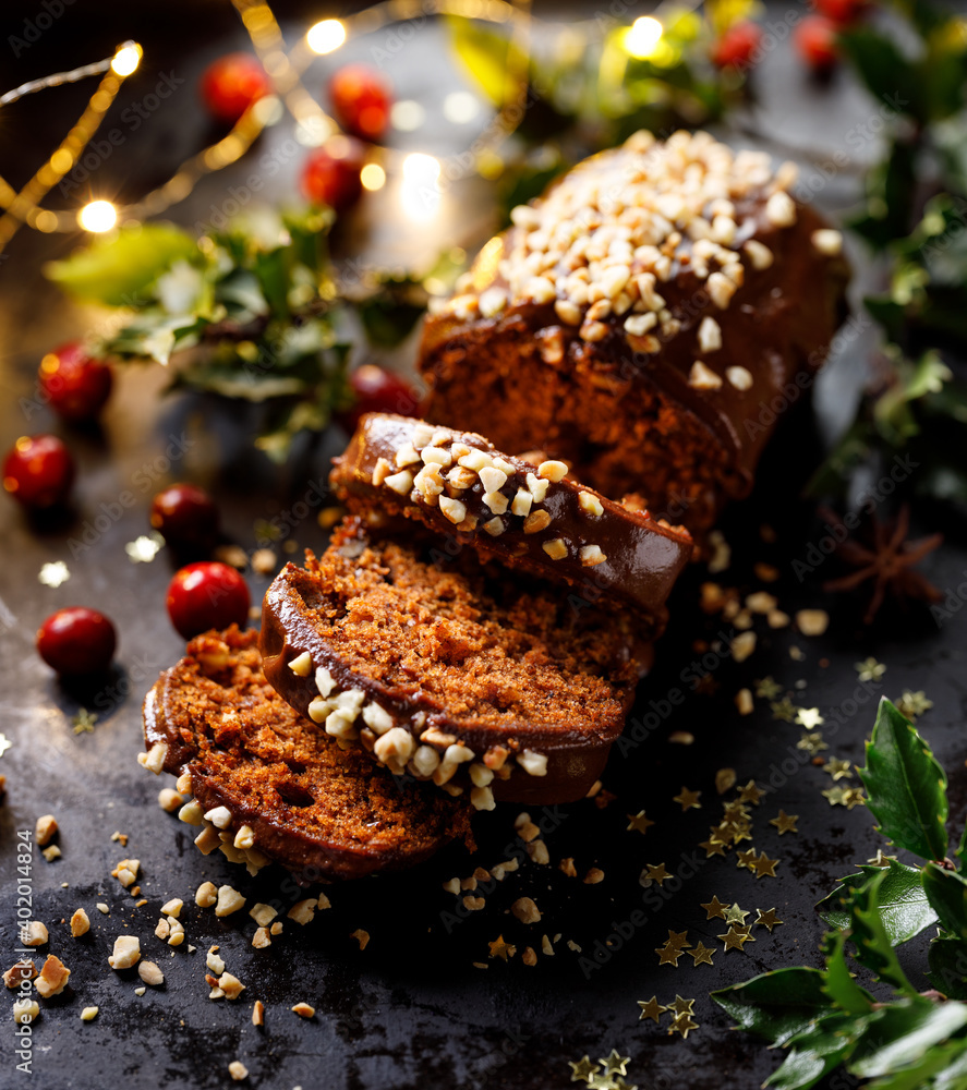 Traditional gingerbread with chocolate glaze sprinkled with chopped almonds close up view