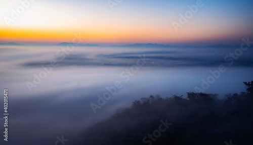 The sea of mist in the winter morning covers the village below in Li District, Lamphun Province, Thailand.