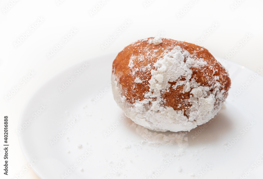 Dish with oliebollen, traditional Dutch pastry for New Year's Eve isolated on white background, pastry, oil dumpling or fritter Dish with oliebollen, traditional Dutch pastry for New Year's Eve isolated on white background, pastry, oil dumpling or fritter