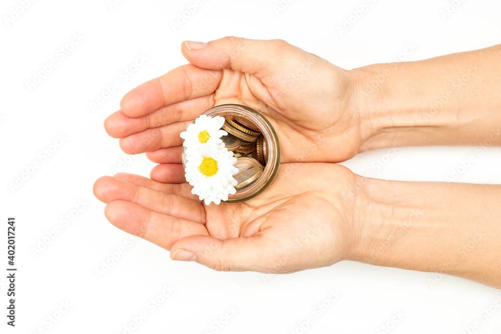 Hand with coins and small flower in a glass jar. Money growth concept. Hand with coins and small flower in a glass jar. Money growth concept.
