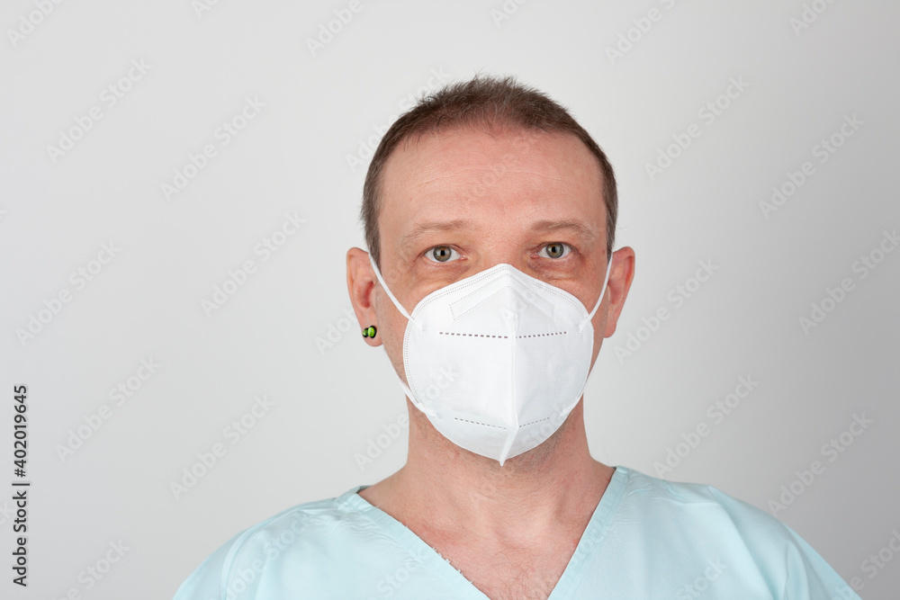 Male nurse, with respirator ffp2, with personal protective equipment to protect against the virus covid-19 in ICU in hospital. Male nurse, with respirator ffp2, with personal protective equipment to protect against the virus covid-19 in ICU in hospital.