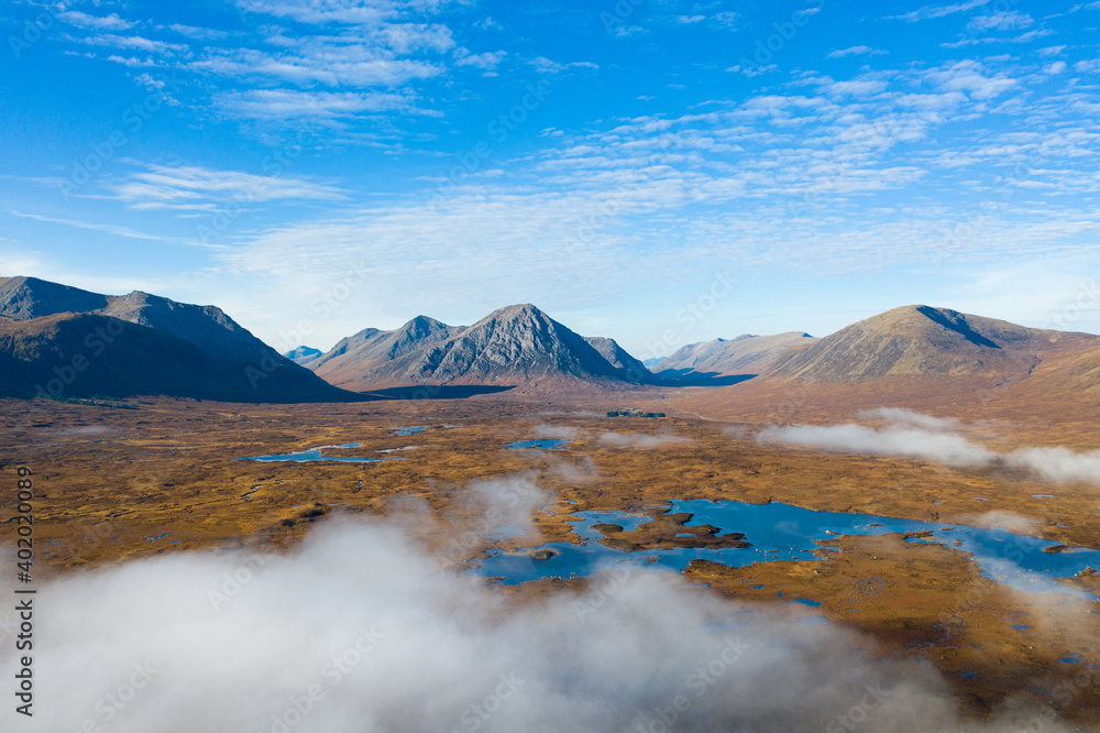 Dramatic Mountain sitting in the Highlands of Scotland with low lying clouds on a perfect day. Dramatic Mountain sitting in the Highlands of Scotland with low lying clouds on a perfect day.