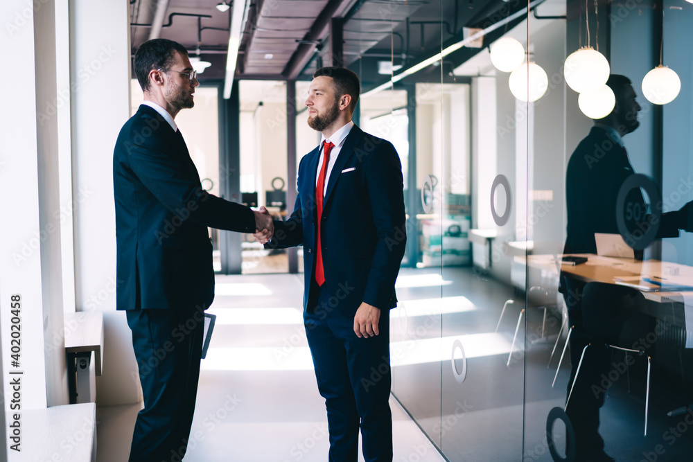 Confident colleagues greeting each other Confident colleagues greeting each other