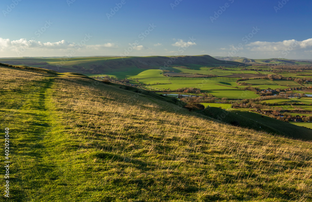 Obraz premium The wonderful views across the East Sussex countryside and the South Downs from Wilmington Hill in south east England