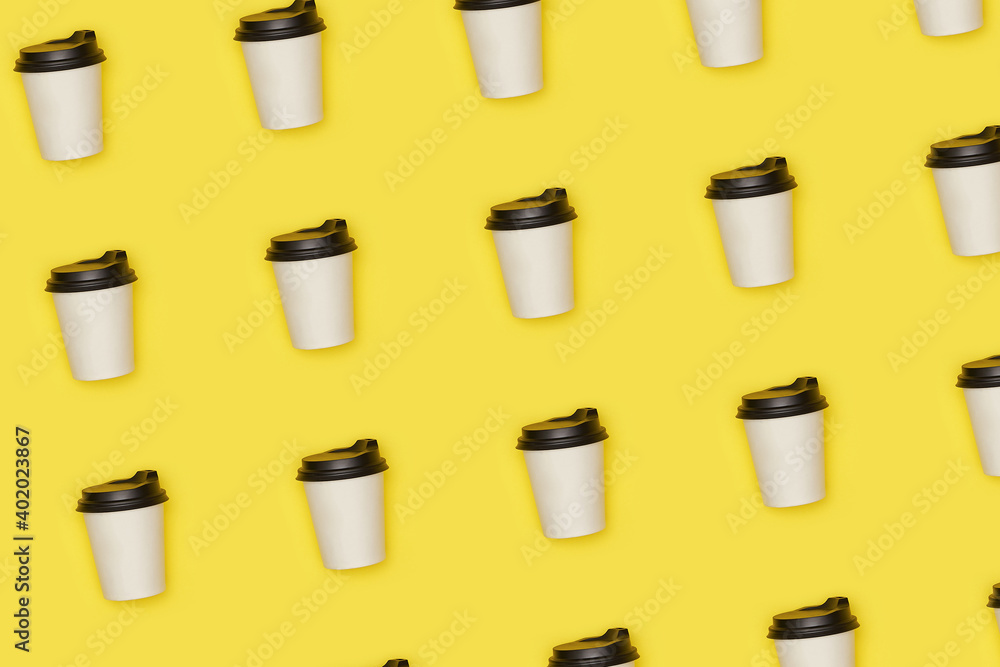Flat lay paper white cup with back plastic cover pattern on yellow background. High quality photo Flat lay paper white cup with back plastic cover pattern on yellow background. High quality photo