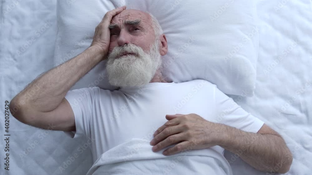 Senior man feeling headache, waking up in the morning, health care, migraine Senior man feeling headache, waking up in the morning, health care, migraine
