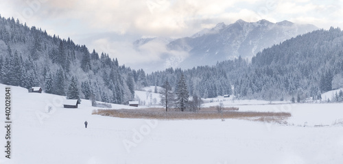 winter landscape panorama with snow covered huts and mountains