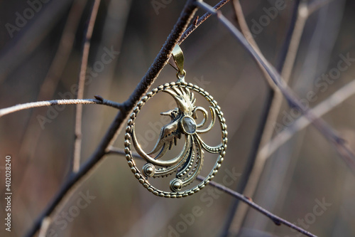Brass pendant in the shape of Phoenix with faceted labradorite