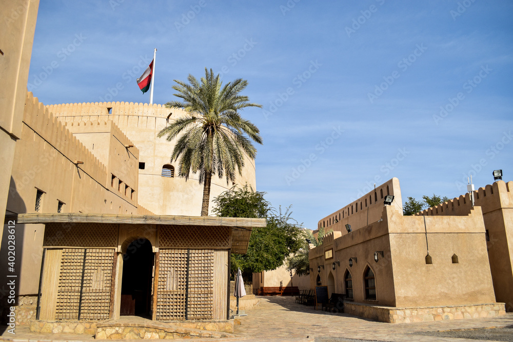 Nizwa Fort and its main tower in contrast with the blue sky. Nizwa, Oman.