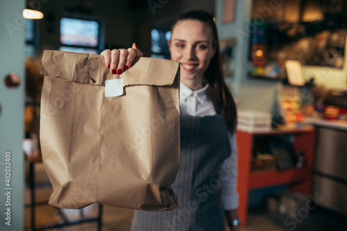 waitress holding prepared takeaway food in eatery. food delivery concept. coronavirus quarantine concept photo