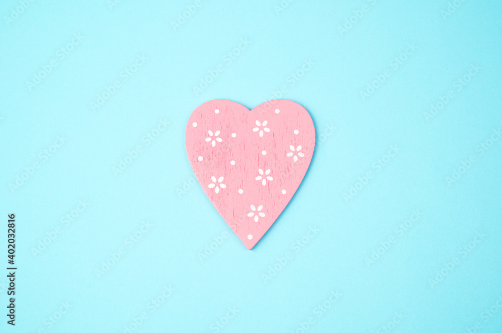 Pink heart on a blue background. Top view, with space to copy.