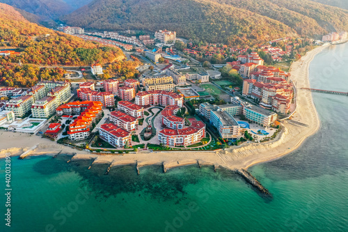 Bulgaria, no tourists, empty beach. Black Sea cost in low season. Hotel buildings, mountains, autumn.