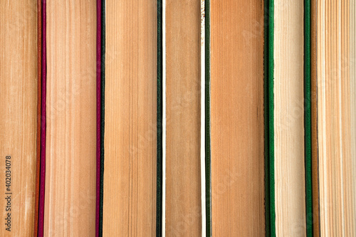 Book background  a stack of books pressed against each other.