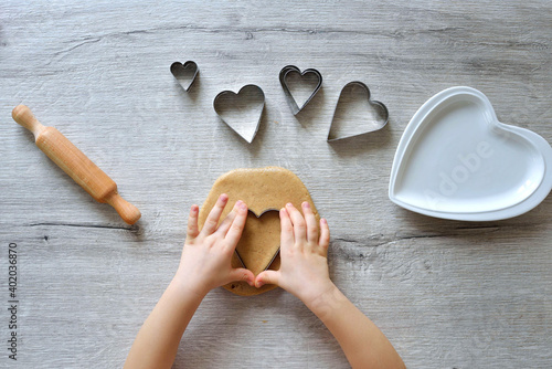 DIY making gingerbread by kid for Valentine's Day for parents. Baking training for children from 4 to 14 years old. early child development of fine motor skills. step by step. step 2