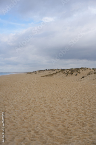 Sand dunes with nobody and a storm behind in Comporta, Portugal