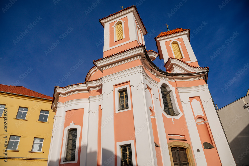 Baroque Chapel of Saint Florian, Narrow picturesque street with historical buildings, Church at the pedestrian zone in Kladno in sunny day, Central Bohemia, Czech Republic