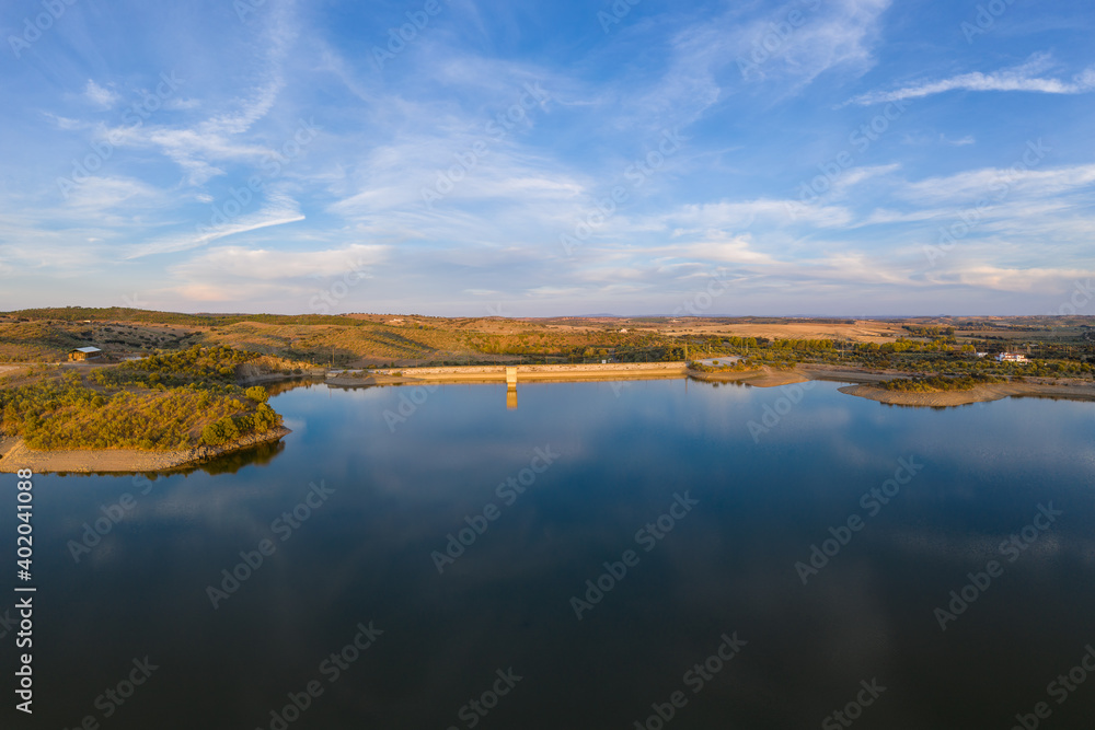 Fototapeta premium Drone aerial panorama of a dam lake reservoir landscape in Terena, Portugal