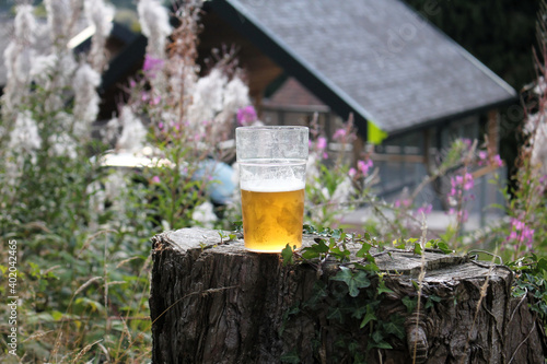 Draft beer glass near the river waterfall, alcohol beverage brewery in the nature