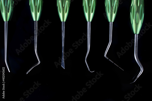 different instruments for dental surgery, top view on a black background photo