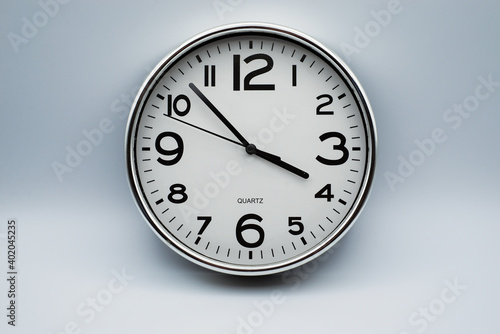 Closeup of retro analog clock on grey background