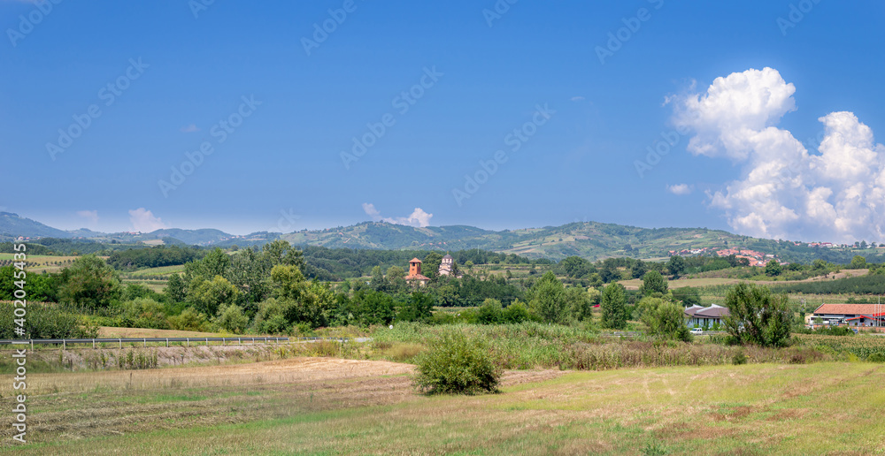 Countryside in summer - small village with church and houses